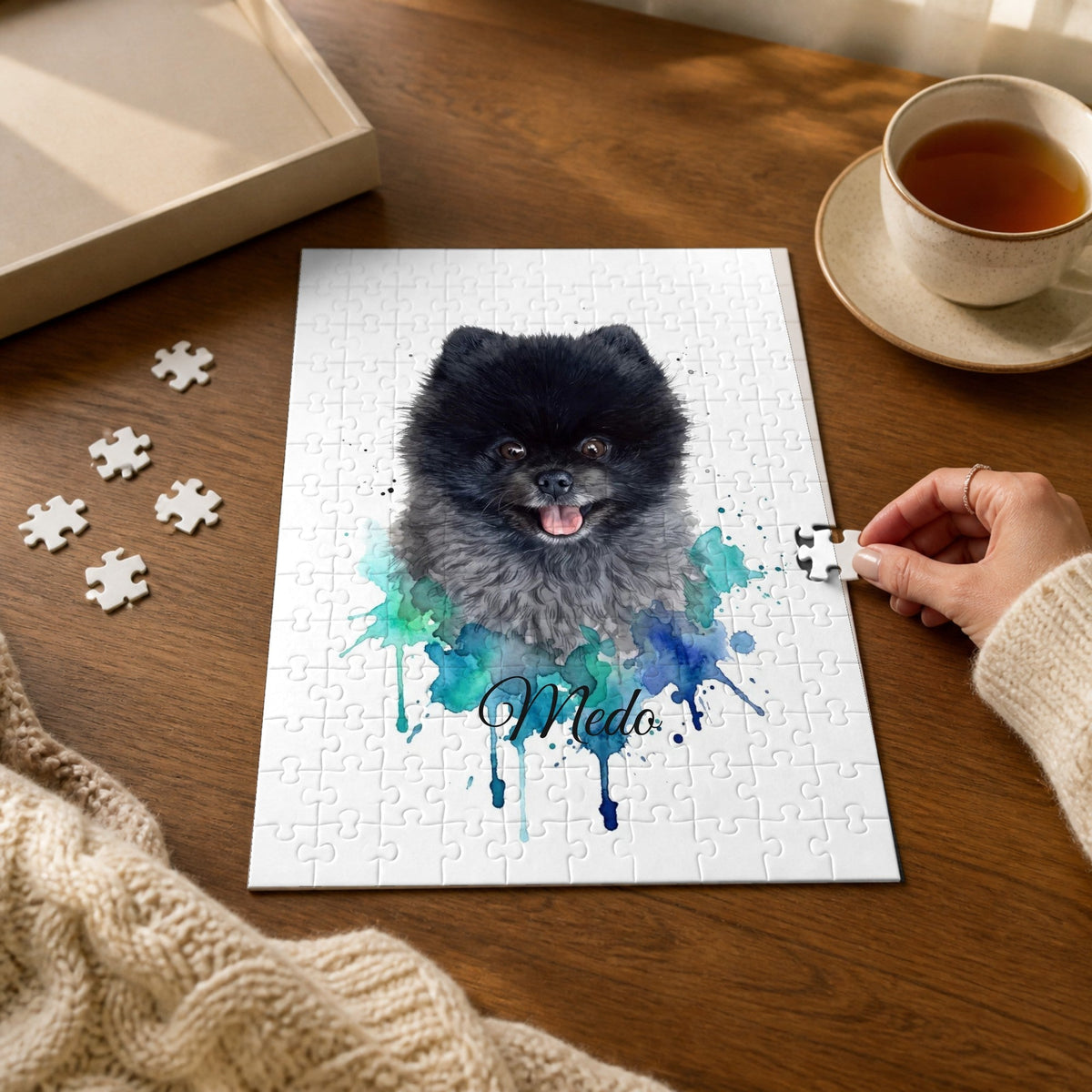 Personalised jigsaw puzzle with a blue watercolour pet portrait on a wooden table